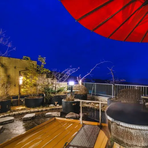 Steam rising from the open-air bath after dark